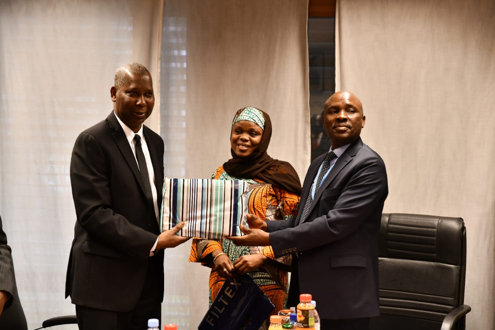 Courtesy Visit of H.E. Tijjani Muhammad Bande, UNGA President to the Mission/H.E. Tijjani M. B. being handed a gift fron the Mission by Charge d